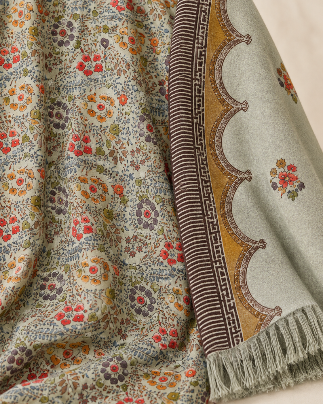 Close view of the sage suit's floral fabric and dupatta border.